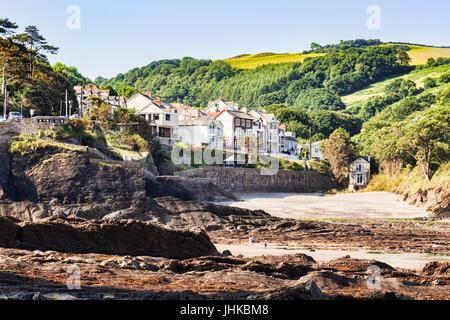 19 June 2017: Combe Martin, Devon, England, UK - The rocky beach and the village. Stock Photo