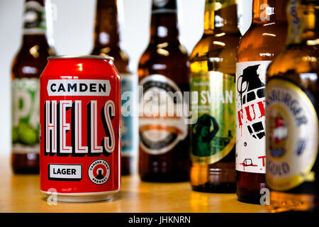 Camden Hells Lager among other beer bottles with heavy depth of field. Stock Photo