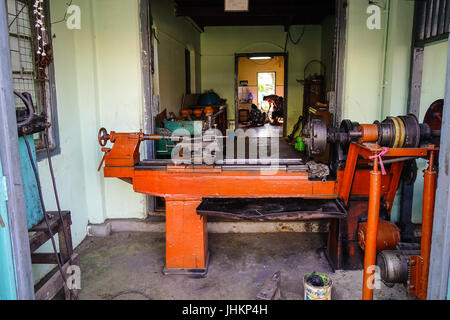 Pyin Oo Lwin, Myanmar - Feb 12, 2017. Metal working machine at the old workshop in Mandalay, Myanmar. The small town of Pyin Oo Lwin is a reminder of  Stock Photo