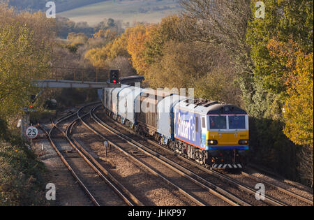 A class 92 electric locomotive number 92017 in Stobart Rail livery working a freight train at Otford Junction in Kent. Stock Photo