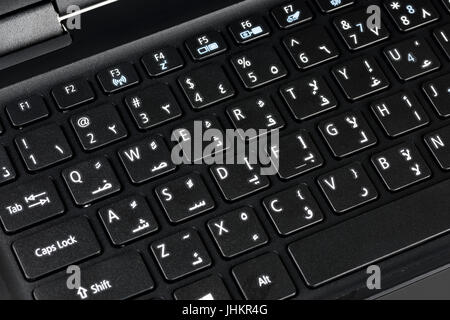 Close up of a QWERTY keyboard english and arabic with letters, figures and symbols Stock Photo
