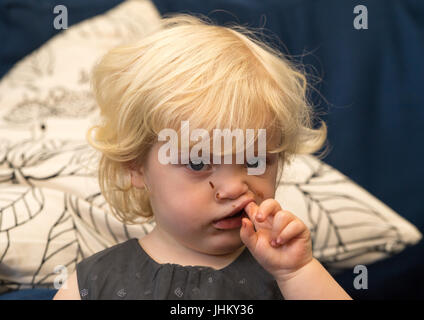 Blond girl with toothache, United Kingdom Stock Photo
