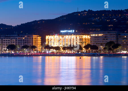 The famous hotel Martinez at the Promenade de la Croisette, Cannes, France at dusk Stock Photo