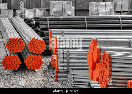Steel Pipes bunch on the rack in warehouse Stock Photo
