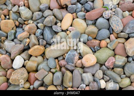 A variety of coloured rocks on a beach in Scotland, UK Stock Photo