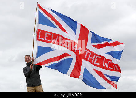 A fan waves a flag in support of Mercedes' Lewis Hamilton during practice of the 2017 British Grand Prix at Silverstone Circuit, Towcester. Stock Photo