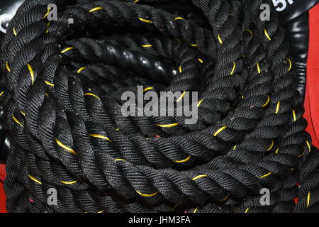 Close up coiled black and yellow rope re climbing re safety re exercise Stock Photo
