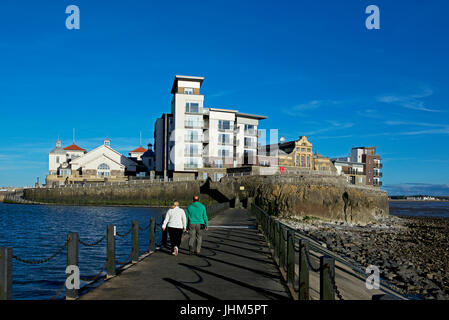 Couple on walkway to Knightstone Island, next to marine lake, Weston-super-Mare, Somerset, England UK Stock Photo