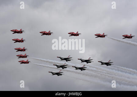 The Royal International Air Tattoo was opened with a unique formation of the RAF Red Arrows with the United States Air Force Thunderbirds display teams Stock Photo