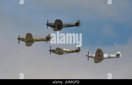 RAF Fairford, Gloucestershire, UK. 14th July 2017. First day of the Royal International Air Tattoo (RIAT), one of the world’s greatest airshows. Flying displays include the Battle of Britain Memorial Flight (photo). A Hawker Hurricane leads three Supermarine Spitfires in the flypast. Credit: Malcolm Park / Alamy Live News. Stock Photo