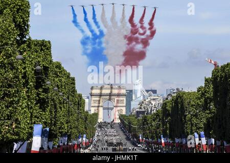 French Alpha jets perform a flyby over the Arc de Triomphe during the annual Bastille Day military parade July 14, 2017 in Paris, France. U.S. President Donald Trump was the guest of honor of French President Emmanuel Macron for the event marking the 100th anniversary of the U.S. entry into World War I. Stock Photo