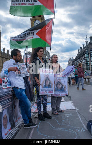 London, UK. 14th July, 2017. London, UK. 14th July 2017. Inminds Palestinian Prisoners Campaign protest on Westminster Bridge in front of the UK Parliament calling for the release of Palestinian MP Khalida Jarrar and the other 10 members of the Palestinian parliament that are currently imprisoned by the Israeli occupation. Speeches, flags, banners, poster and leaflets called on the public who walked past for support, and many stopped to look. Jarrar was abducted by Israeli soldiers on July 2nd and sentenced t to six months administrative detention on 12th July 2017 without charge or trial. Ni Stock Photo