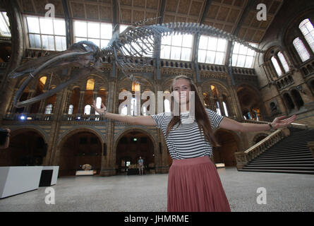 Laura Willis, 25, from County Armagh in Northern Ireland, who won a competition entered by 16,000 people to be the first member of the public to enter the Hintze Hall at the Natural History Museum, London, with the new blue whale skeleton named 'Hope' in the background. Stock Photo
