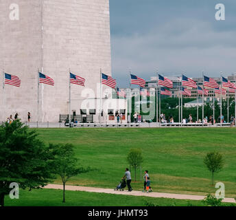 WASHINGTON DC, USA - June, 2017: American flags at the Washington Monument are an obelisk, built to commemorate George Washington, the first American president. Stock Photo