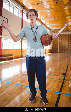 Portrait of angry male coach gesturing while standing in court Stock Photo