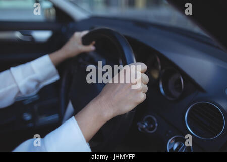 Cropped image of businesswoman driving car Stock Photo