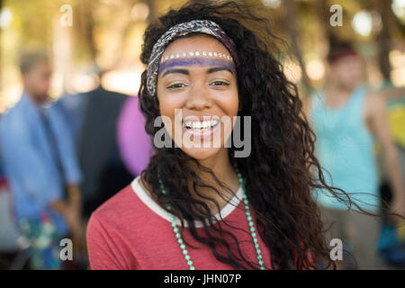 Portrait of smiling young woman with face paint at campsite Stock Photo