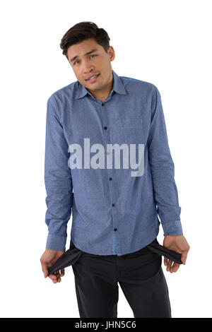 Portrait of businessman showing empty pockets Stock Photo