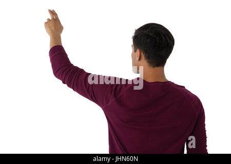 Businessman touching invisible imaginary screen against white background Stock Photo