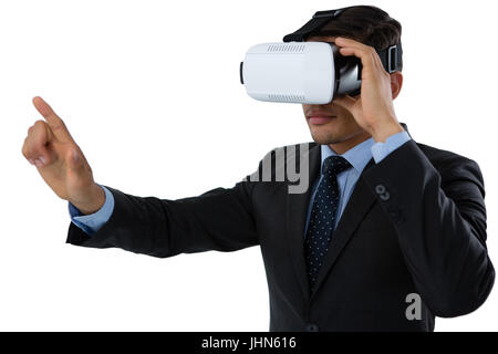 Businessman gesturing while using vr glasses against white background Stock Photo