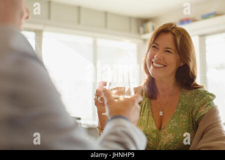 Smiling couple toasting wine glasses at restaurant Stock Photo
