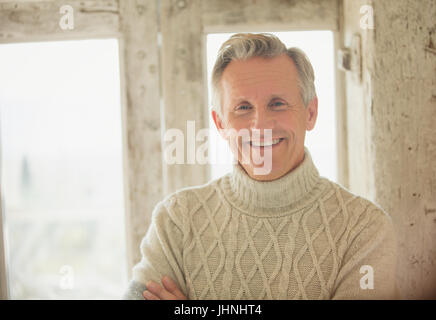 Portrait smiling senior man in turtleneck sweater Stock Photo