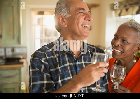 Laughing senior couple drinking white wine Stock Photo