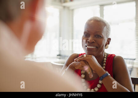 Smiling senior woman dining at restaurant Stock Photo