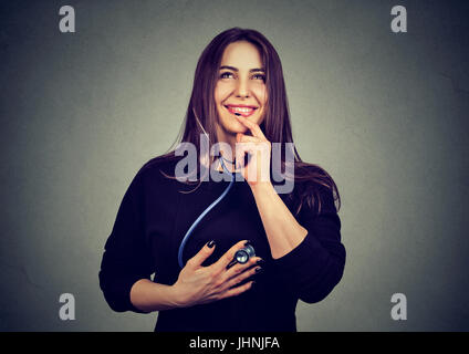 woman listening to her heart with stethoscope Stock Photo