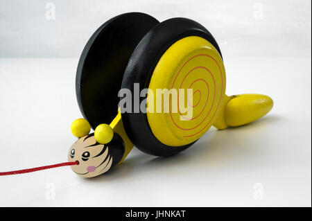 Pull along yellow wooden snail Stock Photo