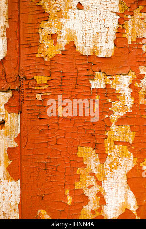 Cracked wall with old layers of paint in abandoned house. Background Stock Photo