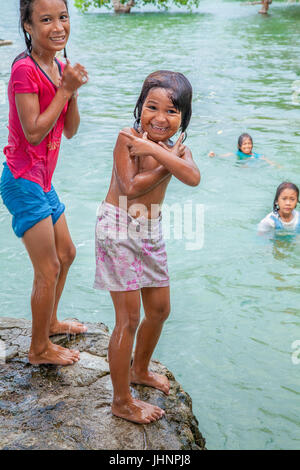 Young Filipino girls playing on a view deck overlooking the Banaue Rice