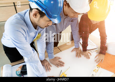 Asian engineer or architect meeting for architectural project. working with partner and engineering tools on workplace. Engineer or architect meeting  Stock Photo