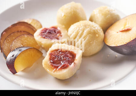 Austrian traditional dumplings filled with plum on white Stock Photo