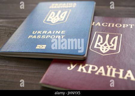 two versions of Ukrainian foreign passports. red document is an old example, blue document is a new biometric passport Stock Photo