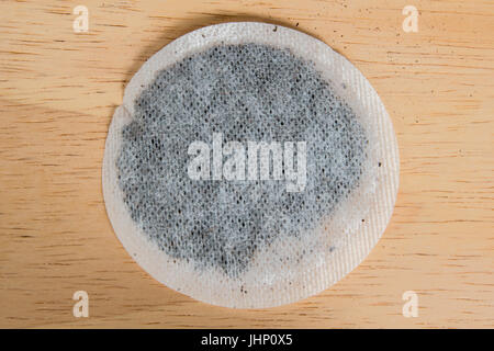 Round tea bags on a wooden background Stock Photo