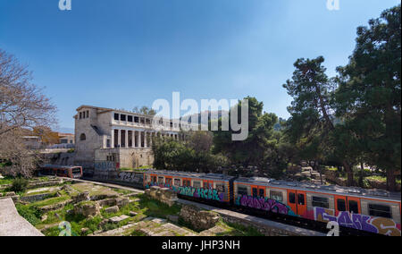 athens, Greece - March 4, 2017:  View of Stoa of Attalos building with Acropolis in the background and overground trains in the foreground Stock Photo