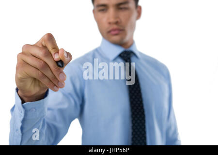 Businessman writing with stylus on interface screen against white background Stock Photo