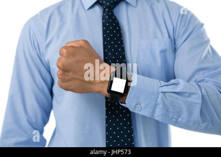 Mid section of businessman showing smartwatch while standing against white background Stock Photo