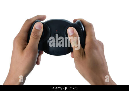 Cropped image of man holding controller against white background Stock Photo