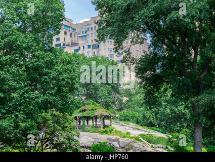 small crude structure in central park with high rise buidings in the distance in NYC. Stock Photo