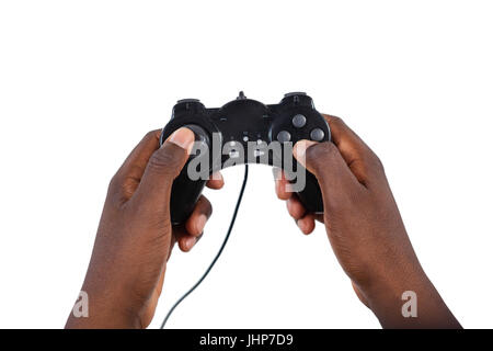 Close-up of mans hand playing video game against white background Stock Photo