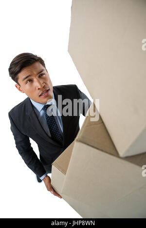 High angle view of businessman carrying cardboard boxes against white background Stock Photo