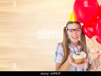 Digital composite of Millennial woman with balloons and cupcake against blurry cream background Stock Photo