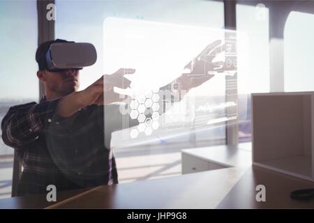 Digital composite of Man in VR headset touching interface Stock Photo