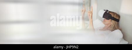 Digital composite of Woman Wearing VR Headset with windows Stock Photo