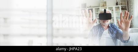 Digital composite of Old man Wearing VR Headset with transition Stock Photo