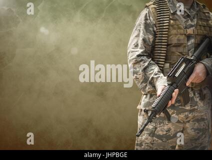 Digital composite of Soldier man holding a weapon against brown background Stock Photo