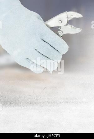 Digital composite of Hand with plier on building site with transition effect Stock Photo