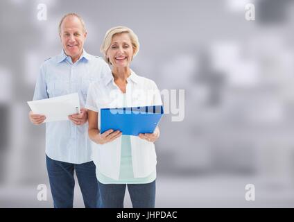 Digital composite of Old Students holding folder in front of blurred background Stock Photo